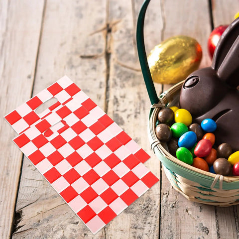 Race Car Themed Gift Bags With Handle Pack Of 50 Portable Lightweight Plastic Candy Bags next to a basket with chocolates and candies