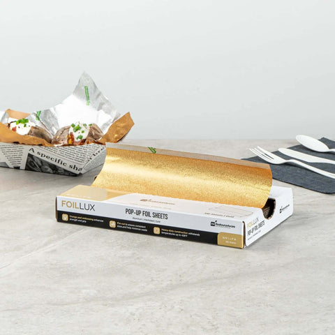 Box of Gold Embossed Pop-Up Foil Sheets 10.8 X 9 Inch Interfolded Greaseproof for fast-service kitchens, with tacos wrapped in foil