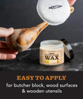Applying wax from Food Grade Perfect Pair Mineral Oil And Carnauba Wax Set For Cutting Boards And Butcher Blocks to wooden spoon