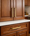 Brushed Brass Cabinet Pulls Set Of 10, 3-Inch Hole Center Handles installed on wooden kitchen cabinets and drawers