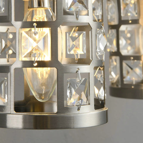 Close-up of crystal shade detail on Three Light Brushed Nickel Vanity Light Fixture With Cylinder Crystal Shades Over Mirror Slick Modern Wall Sconce For Bathroom Powder Room And Dressing Area