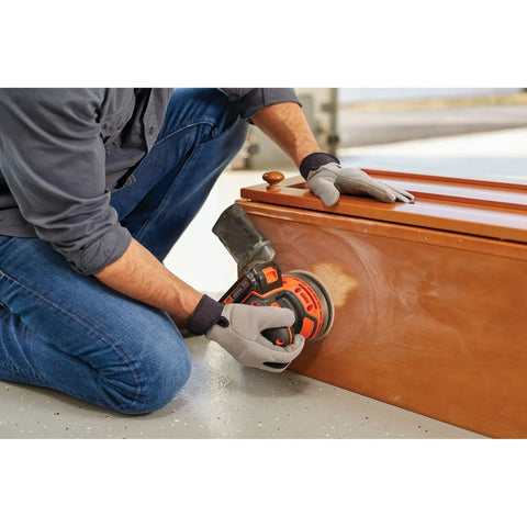 Person using Cordless Orbital Sander With 12,000 OPM For Fast Material Removal on wooden furniture. Lightweight and easy to use.