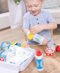Child playing with Get Well First Aid Kit Play Set For Kids With 25 Realistic Medical Tools For Pretend Doctor Play, bandage visible.