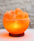 Himalayan Salt Chip Bowl Lamp With Dimmer Switch Hand-Carved Stone Salt Lamp On Premium Wood Base emitting warm glow on table