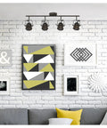 Living room with Boswell Vintage-Style Four-Light Indoor Track Light Kit in oil-rubbed bronze illuminating wall art.