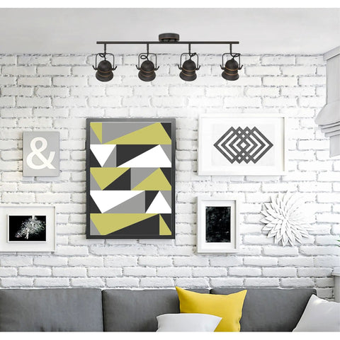 Living room with Boswell Vintage-Style Four-Light Indoor Track Light Kit in oil-rubbed bronze illuminating wall art.