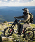 Rider on X2Pro Electric Dirt Bike For Adults With 6000W Peak Motor, full suspension, trail scenery in background
