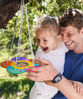 Father and daughter hanging a painted feeder from the Two Pack Diy Wooden Bird Feeder Craft Kits For Kids Outdoor Fun.