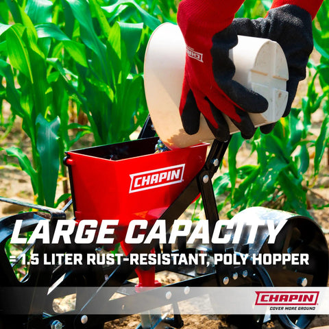 Close-up of Garden Push Seeder Planter With Six Seed Plates For Up To Twenty Seed Varieties Zinc Plow Blade Row Marker Powder Coated Steel Frame in red, showing 1.5 liter hopper being filled.