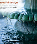 Close-up of water flowing over a green pedestal in the 35 Inch Outdoor Pedestal Water Fountain With 3 Tier Cascade, Durable Resin Birdbath For Garden Patio Deck And Backyard Green Finish, Calming Water Feature For Yard Ambiance And Garden Decor.