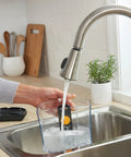 Filling a 12-cup coffee maker reservoir at a kitchen sink with Advanced Water Filter Cartridges For 12-Cup Programmable Coffee Makers.