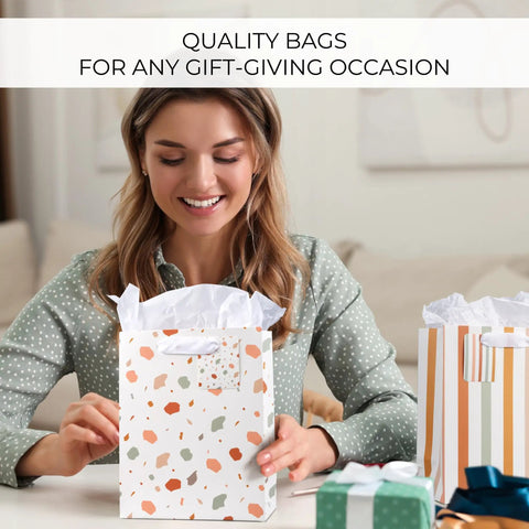 Woman using Grab And Go Medium Sized Gift Bag Set With Handles, 9 Inch, Includes Matching Tissue Paper, Cards, Stickers, And Envelopes.