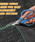 Weed Barrier Landscape Fabric 4 Foot By 100 Foot Woven Ground Cover with green printed guide lines being cut with scissors.