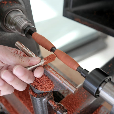 BMWOOD PM-002 MT2 pen mandrel kit in use on a wood lathe with orange bushings and a turned wood pen blank.