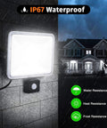 100W Led Floodlights with Motion Sensor, 6000K-6500K Daylight White 80 mounted on a wall in rain, showcasing IP67 waterproof features.