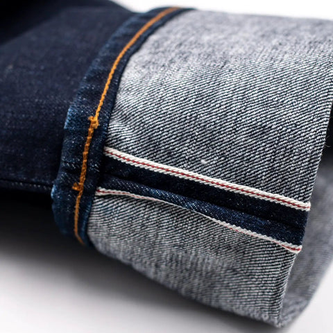 Close-up of 16oz Heavyweight Selvedge Denim Fabric 100 Percent Cotton Raw Indigo side showing selvedge edge detail in narrow width.