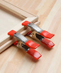 Heavy Duty 1 Inch Steel Spring Clamp Single Pack with Non Marking PVC Tips on wooden frame