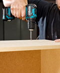 Badass 12v Max Lithium Ion Cxt Brushless Drill Driver Featuring Electric Brake And Bright Led Lamp Keyless Chuck Compact Heavy Duty Cordless Tool Built Different For Real World Projects in use drilling a wood surface.