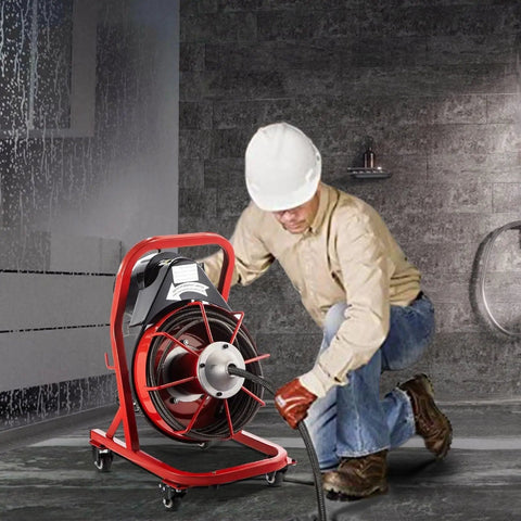 Knockout Heavy Duty Electric Drain Auger With 75 Foot Steel Core Cable in use, clearing kitchen sink clogs by a worker.