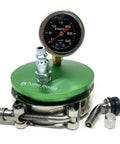 Front view of a medium aluminum boost leak tester with a 3-inch end cap on a green anodized base and pressure gauge.