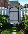 Beefed Up Full Frame Gate Fence Kit For 60 To 96 Inch Openings And Up To 5 Feet High installed on a white picket fence