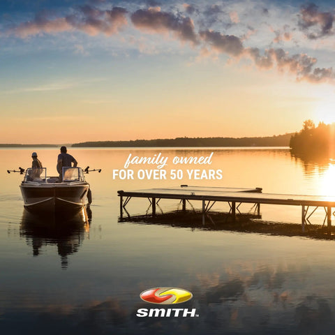 Two people in a boat at sunset near a pier, text overlay 'family owned for over 50 years' and Smith logo visible.