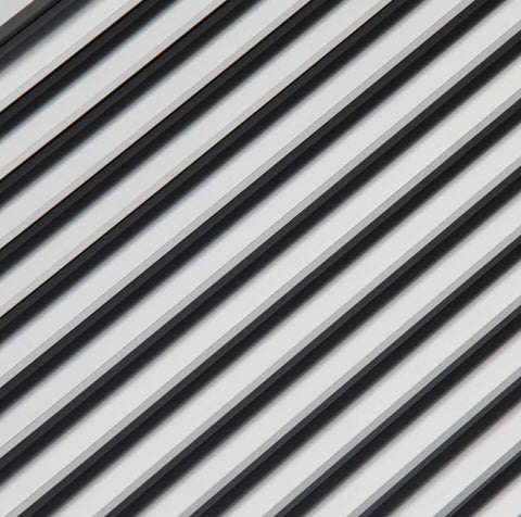Close-up view of Aluminum Privacy HVAC Air Grille 24 By 24 With V Shaped Louvers Blocks 100 Percent View While Still Allowing Air Flow