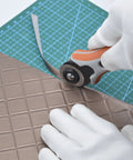 Pro Grade 60mm Rotary Blades Replacement 5 Pack For OLFA Fiskars TrueCut DAFA Cutters Perfect For Quilting Sewing Scrapbooking And Crafts Sharp Durable Premium Japanese Steel For Clean Precise Cuts Every Time used on crafting material with cutting mat visible.