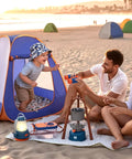 Family playing with Kids Camping Set With Pop Up Tent And Outdoor Gear For Pretend Play Adventures on the beach at sunset