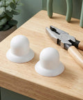 Upgrade Your Shade Game With Sturdy White Patio Umbrella Pole End Cap Replacement Kit Featuring Quick Tool-Free Install, Wind Resistance And Scratch Protection For Beach Tents And Garden Canopies. White plastic cap on wood shelf with pliers