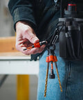 Five Pack One Quarter Inch Hex Shank Bit Holder Keychain Set in use with orange aluminum quick release holders and drill bits