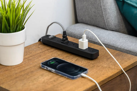 Twin Pack Six Outlet Surge Protector Power Strip With 3 Foot Extension Cord for home and office, black, on wooden table
