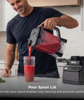Top Shelf Professional Blender With 1200 Watt Motor And Auto Iq Technology 72 Oz Pitcher pouring smoothie into cup