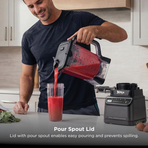 Top Shelf Professional Blender With 1200 Watt Motor And Auto Iq Technology 72 Oz Pitcher pouring smoothie into cup