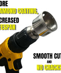 Close-up of a cordless yellow drill with a diamond-coated hole saw bit attached.