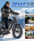 Man riding Powerful 1500W Fat Tire Electric Bike For Adults With Dual Suspension on snow; 20 inch off-road ebike in action.