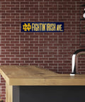 Notre Dame Fighting Irish 16 Inch Plastic Street Sign Wall Decor displayed on a brick wall, perfect for game day and tailgates.