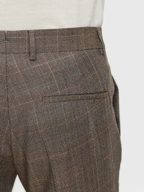 Close-up of back pocket on brown plaid dress pants with belt loops