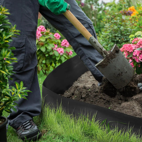 Gardener using a shovel near 6 Inch Tall Landscape Plastic Edging Kit With 66 Ft Length And Hammer Spikes For Easy Install Garden Border