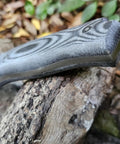 Close-up of Survival Knife For Camping And Bushcraft With 14.5 cm Drop Point Blade In Stainless MOVA 1.4116 Black Micarta Handle