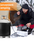 Camper using a Gas Cylinder Heater Wrap With Thermostatic Control for 20-40 lb LP Tanks in a snowy outdoor campsite.