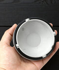 Hand holding Toyota Highlander Front Headlight Dust Cover Replacement Gray Bulb Extension Cap for 2018-2021 models