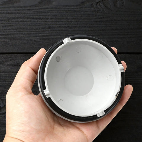 Hand holding Toyota Highlander Front Headlight Dust Cover Replacement Gray Bulb Extension Cap for 2018-2021 models