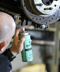 Person using Low Viscosity Penetrating Oil For Rusted Bolts And Fittings With Fast Wicking Action And Residual Lubrication Bolt Loosener Spray 11 Oz on a vehicle part