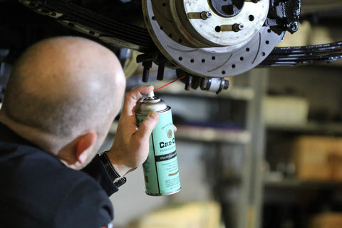 Person using Low Viscosity Penetrating Oil For Rusted Bolts And Fittings With Fast Wicking Action And Residual Lubrication Bolt Loosener Spray 11 Oz on a vehicle part