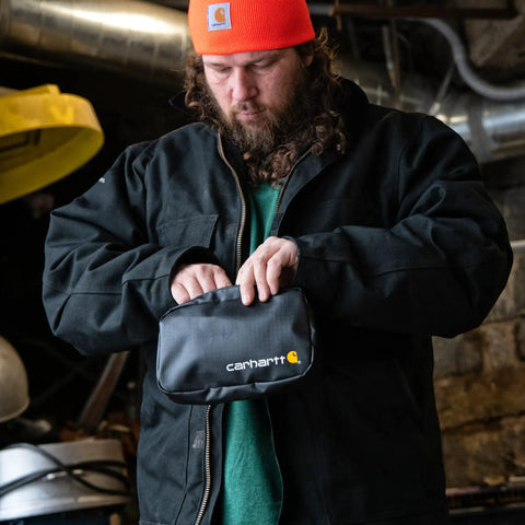 Man holding Cargo Series Weatherproof Hook-N-Haul Utility Bag With Retractable Hooks in black TPU-coated fabric