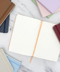 Top Shelf Hardcover Lined Journal Notebook With College Ruled Pages For Your Daily Grind And Heavy Note Taking on a marble surface.