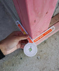Badass 3-Way Bevel Angle Finder And Miter Protractor With Integrated Spirit Level used for measuring angles on a wood structure.