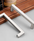 Square Kitchen Cabinet Handles Brushed Nickel Stainless Steel Euro Bar Pulls With Five And One Half Inch Total Length And 128 Millimeter Hole Centers Modern Hardware For Cabinets And Drawers, two handles displayed on a wooden surface.