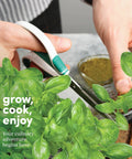 Hand trimming fresh herbs from 9 Herb Indoor Window Garden Kit With Seed Starter For Fresh Homegrown Herbs, Easy To Grow In Kitchen